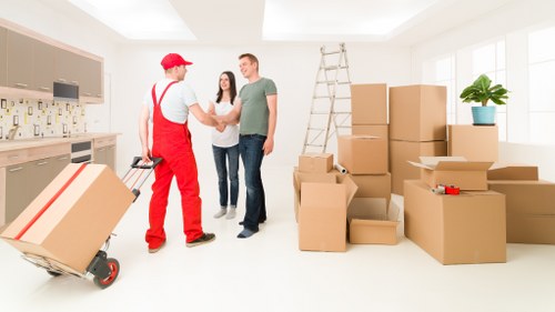 Packed household items and moving boxes in a Chiswick storage setup